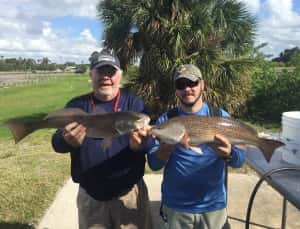 Father and Son Fishing Tandem with Monster Redfish